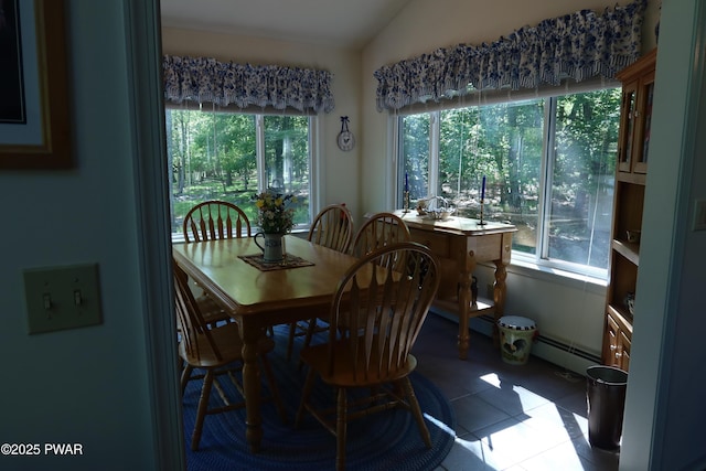 143 Heritage Dr, Lackawaxen, PA 18435 - dining space with a baseboard heating unit, lofted ceiling, and tile patterned flooring