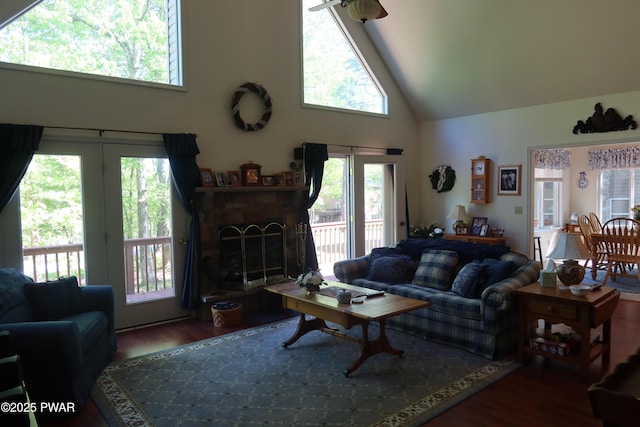 143 Heritage Dr, Lackawaxen, PA 18435 - living area with high vaulted ceiling, wood finished floors, plenty of natural light, and a fireplace with raised hearth