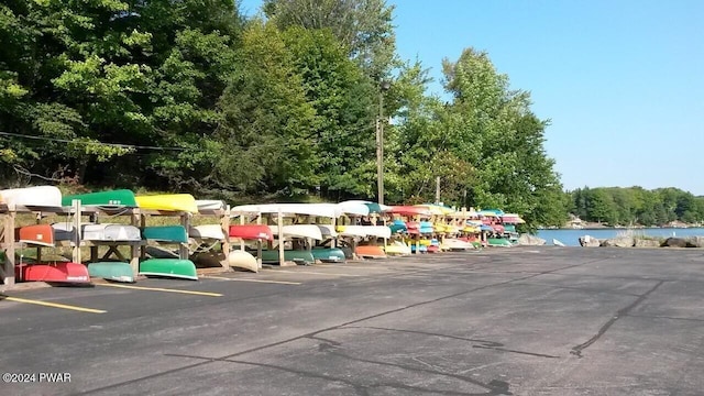 view of vehicle parking featuring a water view