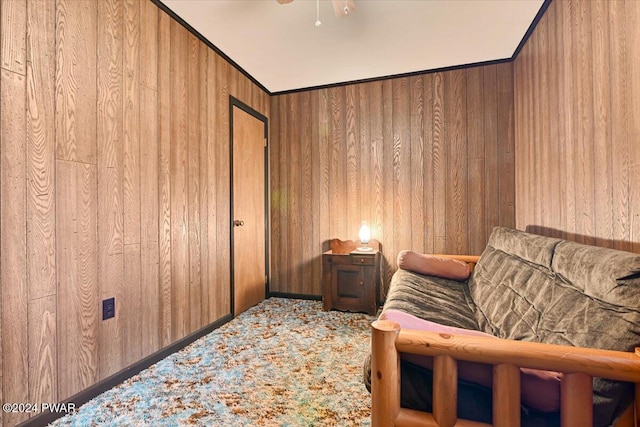 unfurnished room featuring ceiling fan and wood walls