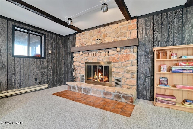 living room featuring beam ceiling, baseboard heating, a stone fireplace, wooden walls, and carpet