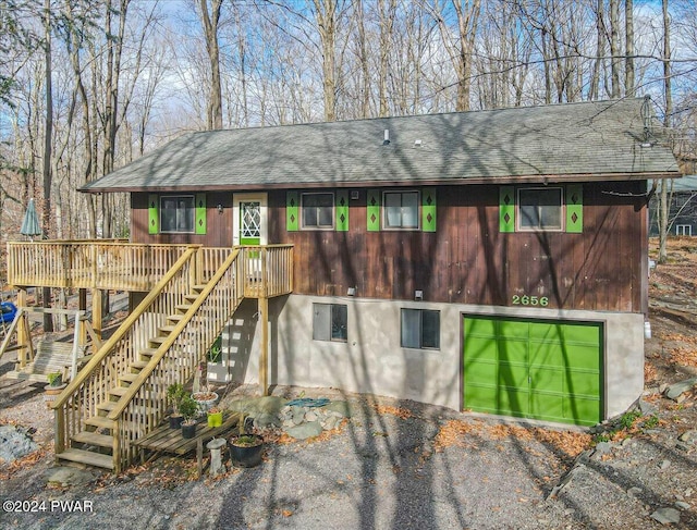 exterior space with a garage and a deck