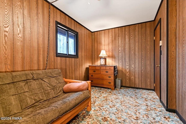 living area featuring wood walls and ornamental molding