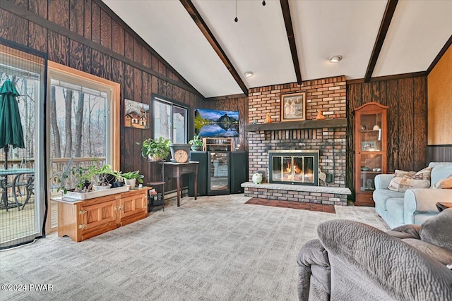 carpeted living room with vaulted ceiling with beams, wood walls, and a brick fireplace