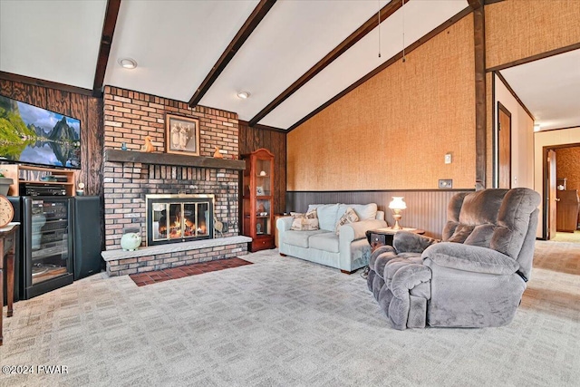 carpeted living room featuring wooden walls, lofted ceiling with beams, and a brick fireplace