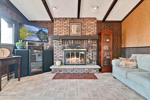 living room featuring a baseboard radiator, vaulted ceiling with beams, carpet floors, wooden walls, and a fireplace