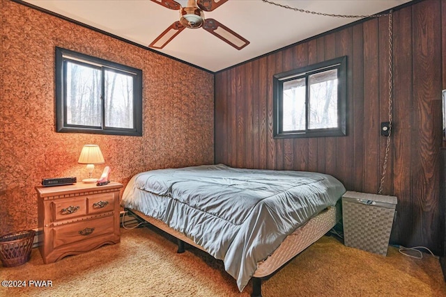 bedroom with multiple windows, carpet flooring, ceiling fan, and ornamental molding