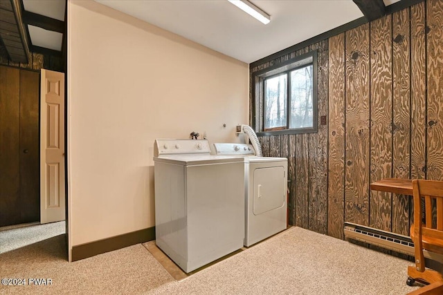 laundry area featuring wood walls, light carpet, and independent washer and dryer