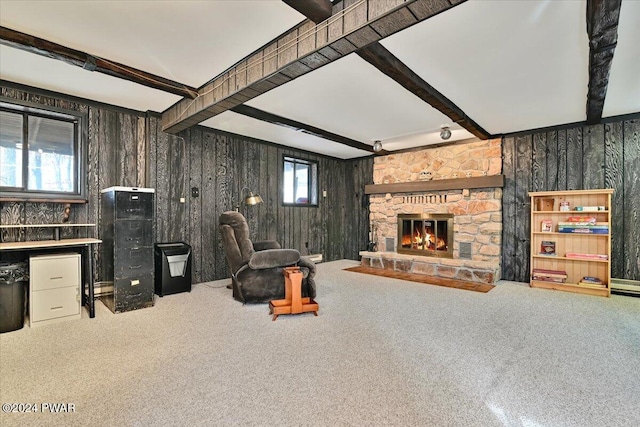 carpeted living room with a fireplace and beamed ceiling