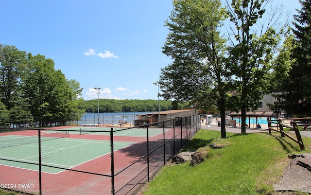 view of sport court featuring a water view