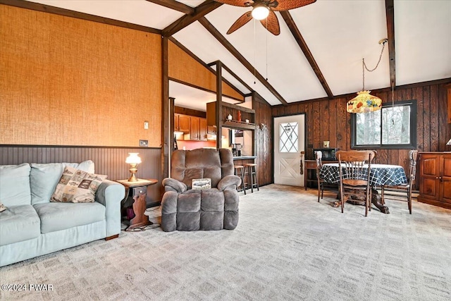 living room featuring vaulted ceiling with beams, ceiling fan, and light carpet