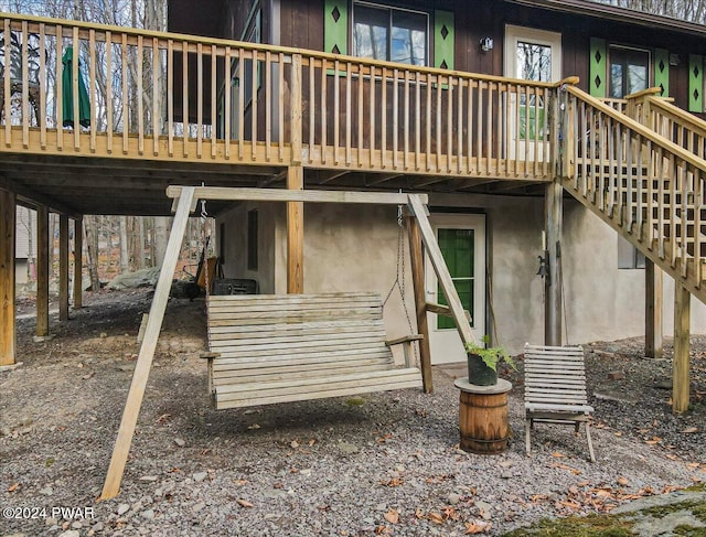 back of house featuring a wooden deck