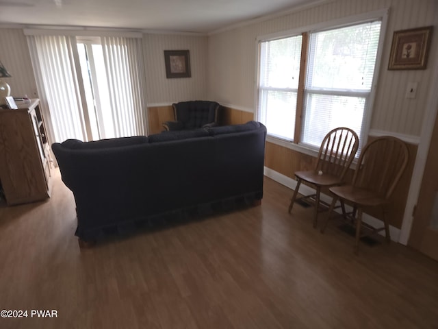 living room with hardwood / wood-style flooring, plenty of natural light, and ornamental molding