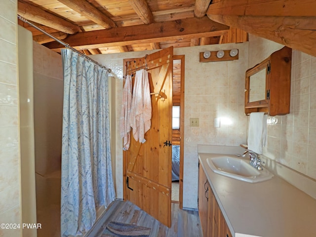 bathroom featuring wooden ceiling, a shower with curtain, beamed ceiling, hardwood / wood-style floors, and tile walls