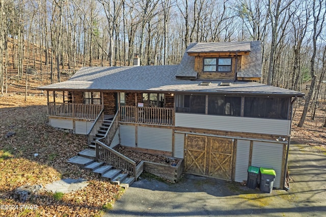 view of front of property with a sunroom