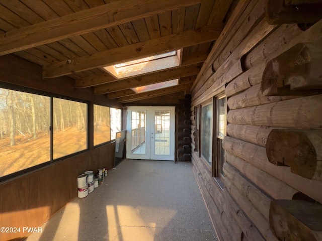 sunroom featuring lofted ceiling with skylight and wooden ceiling