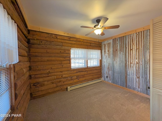 carpeted spare room featuring rustic walls, baseboard heating, and ceiling fan