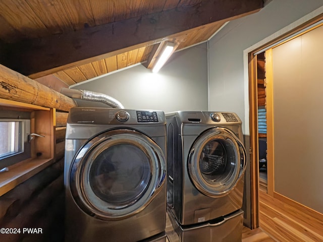 laundry room with light hardwood / wood-style floors, wood ceiling, and independent washer and dryer