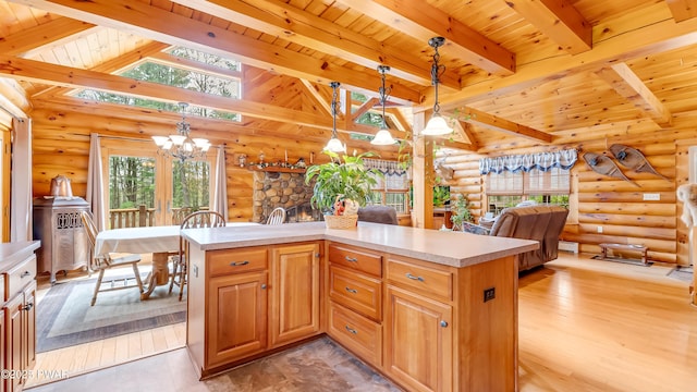 kitchen featuring an inviting chandelier, wood ceiling, vaulted ceiling with beams, and rustic walls