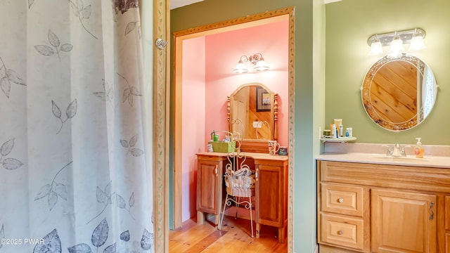 full bathroom featuring vanity, wood finished floors, and a shower with curtain