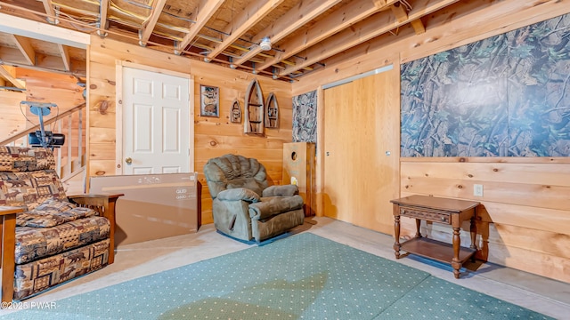 sitting room featuring wooden walls