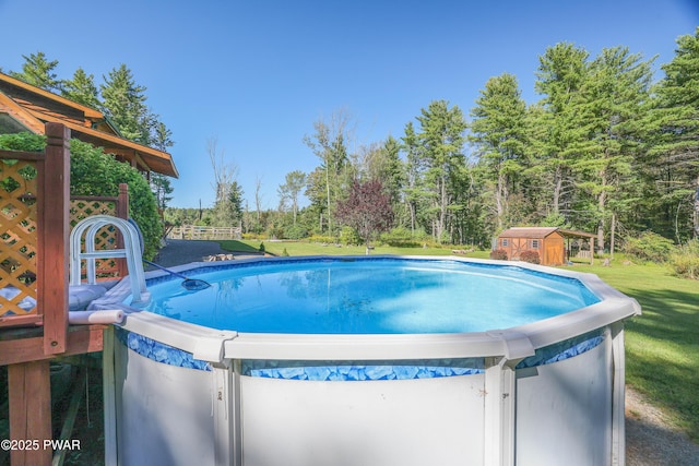 pool with an outdoor structure, a lawn, and a shed