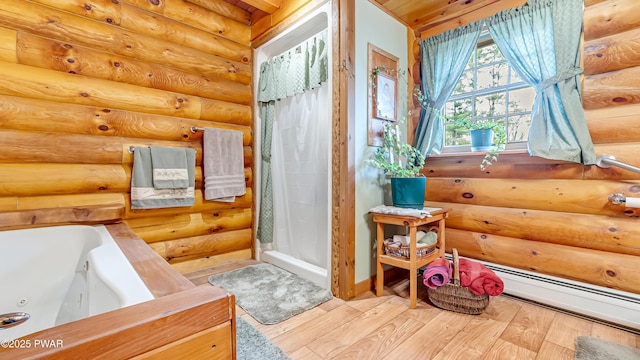 bathroom with baseboard heating, a tub with jets, wood finished floors, rustic walls, and a stall shower