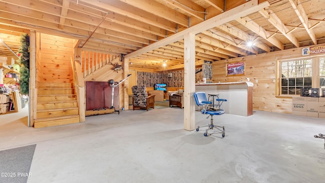 basement with wood walls and stairs