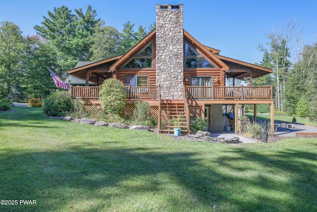 rear view of house featuring a deck, a chimney, stairs, log siding, and a lawn