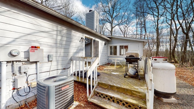 deck with area for grilling and central AC unit