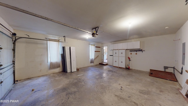 garage with electric panel and a garage door opener