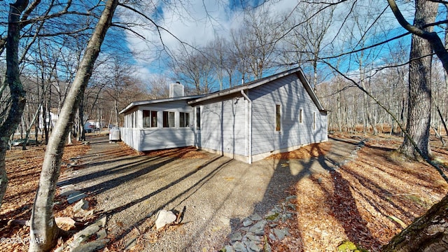 view of home's exterior with a sunroom