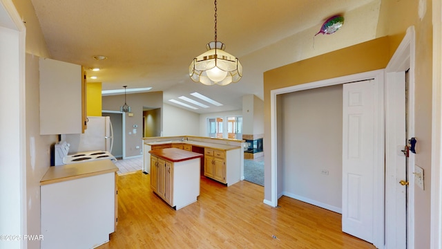 kitchen featuring white appliances, hanging light fixtures, lofted ceiling, and kitchen peninsula