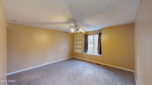 carpeted empty room featuring a textured ceiling and ceiling fan