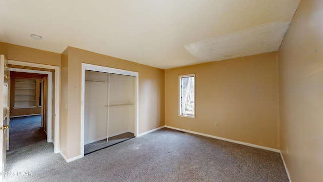 unfurnished bedroom with a closet and carpet flooring