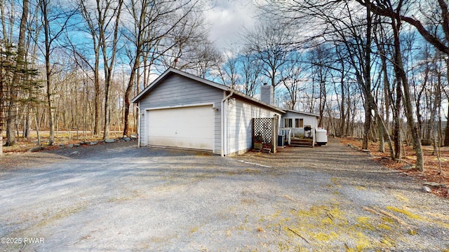 view of side of property with a garage and an outdoor structure