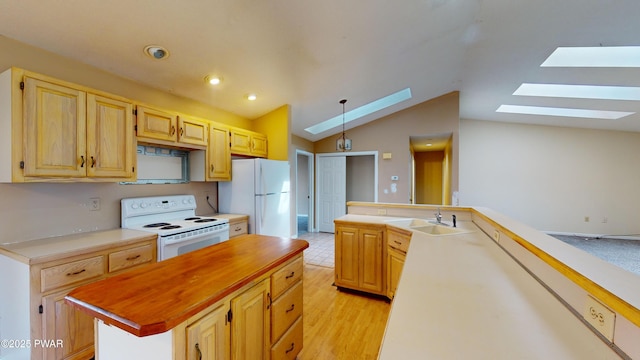 kitchen with sink, a center island, white appliances, light hardwood / wood-style floors, and vaulted ceiling with skylight