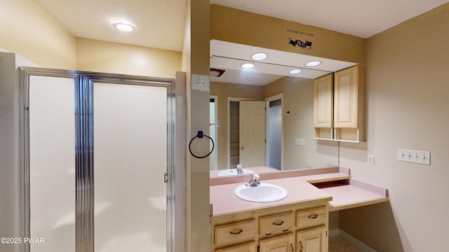 bathroom featuring an enclosed shower and vanity