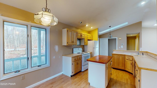 kitchen with white appliances, vaulted ceiling, decorative light fixtures, and a center island