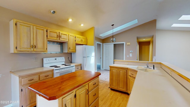 kitchen with white appliances, light wood-type flooring, lofted ceiling with skylight, a kitchen island, and sink