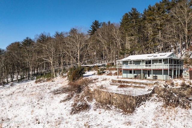 snow covered property featuring a wooden deck