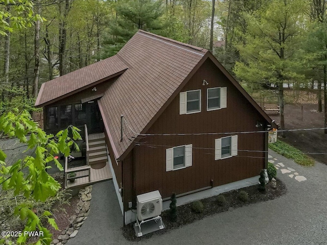 32 White Oak Dr, Lakeville, PA 18438 - view of home's exterior featuring a cooling unit and a wooded view