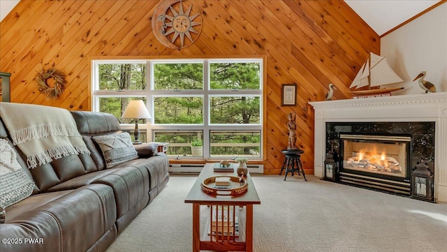 32 White Oak Dr, Lakeville, PA 18438 - living room with vaulted ceiling, a premium fireplace, wooden walls, carpet floors, and a baseboard heating unit