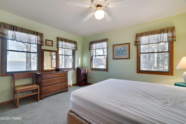 bedroom featuring ceiling fan and light carpet