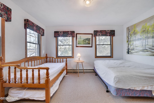 carpeted bedroom with a baseboard heating unit