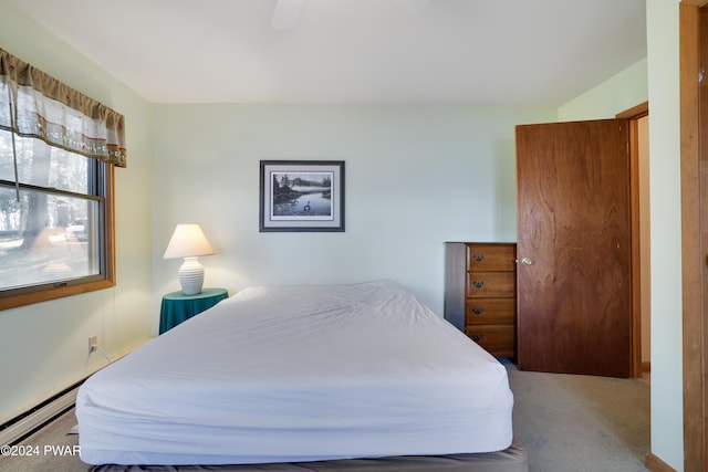 carpeted bedroom featuring baseboard heating and ceiling fan