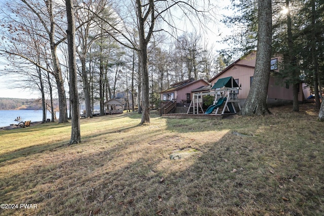 view of yard featuring a water view and a playground