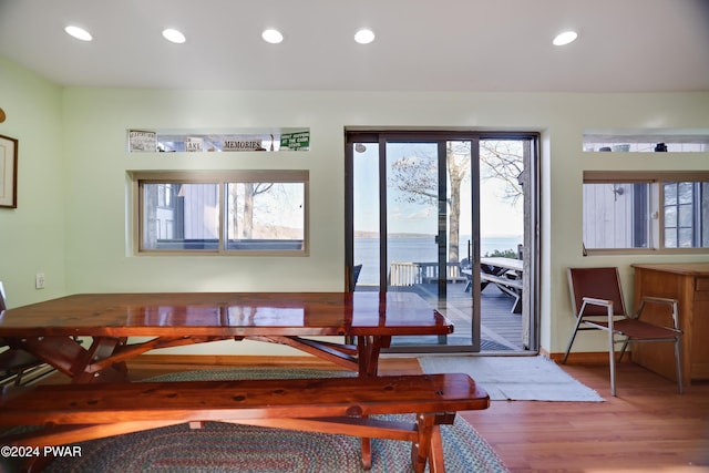 dining room with a water view and light wood-type flooring