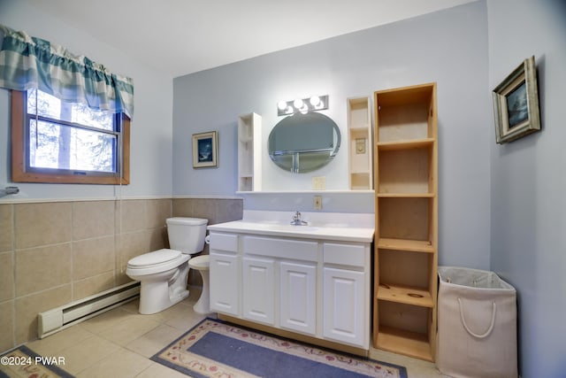 bathroom featuring vanity, a baseboard heating unit, tile walls, tile patterned flooring, and toilet