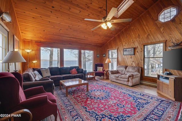 living room with ceiling fan, wooden ceiling, hardwood / wood-style floors, wooden walls, and a water view